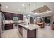 Gourmet kitchen featuring dark wood cabinets, granite island, and stainless steel appliances at 5209 Lake Overlook Ave, Bradenton, FL 34208