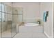 Bathroom features a large walk-in shower and a corner soaking tub at 5209 Lake Overlook Ave, Bradenton, FL 34208