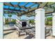 Outdoor kitchen and seating area with pergola and fireplace at 5209 Lake Overlook Ave, Bradenton, FL 34208