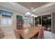 Bright dining room with wooden table and wicker chairs near sliding doors at 5209 Lake Overlook Ave, Bradenton, FL 34208