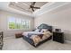 Spacious bedroom with a king-size bed, window shutters, and ceiling fan at 5209 Lake Overlook Ave, Bradenton, FL 34208