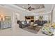 Open and bright living room with leather sofas, kitchen view, and access to backyard at 5209 Lake Overlook Ave, Bradenton, FL 34208