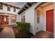 Brick pathway to covered entry with lush landscaping at 5209 Lake Overlook Ave, Bradenton, FL 34208