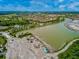 Aerial view of community with lake and construction at 10339 Highland Park Pl, Palmetto, FL 34221