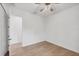 Spacious bedroom with light wood floors, ceiling fan, and white walls at 201 S Shade Ave, Sarasota, FL 34237