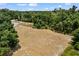 Cleared lot showcasing potential for building amidst lush greenery, offering privacy and space at 7416 41St E Ave, Bradenton, FL 34208