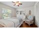 Bright bedroom featuring a ceiling fan, a woven chair, and a white dresser with stylish accents at 808 Ponderosa Pine Ln, Sarasota, FL 34243