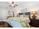 Spacious bedroom with wood floors, tropical bedding, and ample natural light at 808 Ponderosa Pine Ln, Sarasota, FL 34243