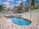 Inviting kidney-shaped pool with brick pavers and privacy fence at 219 81St St, Holmes Beach, FL 34217