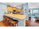 Modern kitchen with light wood cabinets, stainless steel appliances, and breakfast bar at 219 81St St, Holmes Beach, FL 34217