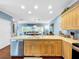 Bright kitchen with stainless steel appliances and light wood cabinets at 219 81St St, Holmes Beach, FL 34217