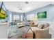Bright living room with comfy seating, large TV, and a coastal decor at 219 81St St, Holmes Beach, FL 34217