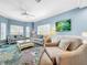 Bright living room with comfy seating, large windows, and a coastal feel at 219 81St St, Holmes Beach, FL 34217