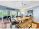 Bright dining room with wood table and bench, access to a balcony at 219 81St St, Holmes Beach, FL 34217