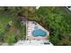 An elevated view of a kidney-shaped pool with surrounding patio and lush landscaping at 219 81St St, Holmes Beach, FL 34217