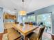 Light and airy dining room features a large wooden table with built-in wet bar at 219 81St St, Holmes Beach, FL 34217