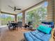 Relaxing screened balcony with outdoor seating and lush greenery views at 219 81St St, Holmes Beach, FL 34217