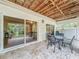 Covered patio with table and chairs, overlooking backyard at 219 81St St, Holmes Beach, FL 34217