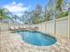 Kidney shaped pool with lounge chairs and fenced backyard at 219 81St St, Holmes Beach, FL 34217