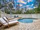 Private pool and patio area with lounge chairs and a hot tub at 219 81St St, Holmes Beach, FL 34217