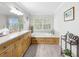 Elegant bathroom with soaking tub, double vanity, and large window at 219 81St St, Holmes Beach, FL 34217
