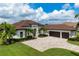 Single-story home with tile roof, three-car garage, and landscaped yard at 8480 Lindrick Ln, Bradenton, FL 34202