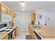 Kitchen with wood cabinets, appliances, and sink at 4850 51St W St # 4204, Bradenton, FL 34210