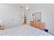 Cozy bedroom with a dresser, double bed, and view into kitchen at 4850 51St W St # 4204, Bradenton, FL 34210