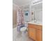 Clean bathroom with a tub, shower, and wood vanity at 4850 51St W St # 4204, Bradenton, FL 34210