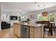 Open-concept kitchen and dining area with granite countertops and stainless steel appliances at 4805 2Nd Ave, Holmes Beach, FL 34217