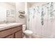 Clean bathroom featuring a shower/tub combo with a decorative curtain and floating shelves for storage at 7380 Mikasa Dr, Punta Gorda, FL 33950