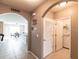 Arched hallway leading to an open-concept kitchen and dining area and a laundry room at 7380 Mikasa Dr, Punta Gorda, FL 33950