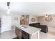 Kitchen island with stone countertops and sink area, plus an adjacent living room at 7380 Mikasa Dr, Punta Gorda, FL 33950