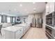 Open-concept kitchen boasts stainless steel appliances and a large center island at 7380 Mikasa Dr, Punta Gorda, FL 33950