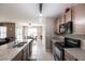 Open kitchen with stainless steel appliances, granite countertops and a view of the dining and living areas at 7380 Mikasa Dr, Punta Gorda, FL 33950