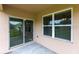 Covered patio featuring sliding glass doors and a large window overlooking a fenced backyard at 7380 Mikasa Dr, Punta Gorda, FL 33950