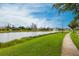 Scenic community lake with walking path and lush landscaping at 7380 Mikasa Dr, Punta Gorda, FL 33950