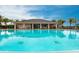 Community pool with adjacent clubhouse at 7380 Mikasa Dr, Punta Gorda, FL 33950
