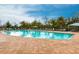 Community pool with lounge chairs and covered seating at 7380 Mikasa Dr, Punta Gorda, FL 33950