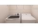 Bright laundry room with washer and dryer, and overhead rack at 7380 Mikasa Dr, Punta Gorda, FL 33950
