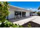 Spacious backyard patio with sliding doors and outdoor seating area at 506 69Th St, Holmes Beach, FL 34217
