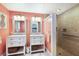 Well-designed bathroom boasts dual vanities and a glass-enclosed shower, combining style and functionality for a spa-like feel at 506 69Th St, Holmes Beach, FL 34217
