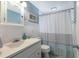 Neat bathroom with a vanity and framed mirror features coastal decor, and a shower/tub combo with a curtain at 506 69Th St, Holmes Beach, FL 34217