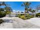 Single-story home featuring well-maintained front yard and a concrete driveway leading to a two-car garage at 506 69Th St, Holmes Beach, FL 34217