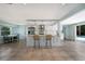 Open floor plan with kitchen island featuring seating, stainless steel appliances, and a view of the pool at 506 69Th St, Holmes Beach, FL 34217