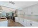 Bright kitchen with white cabinets, stainless steel appliances, and a cozy dining area at 506 69Th St, Holmes Beach, FL 34217