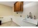 Functional laundry room features ample storage and a utility sink at 506 69Th St, Holmes Beach, FL 34217