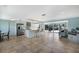 Open floor plan with a spacious living room, tile floors, kitchen island, and sliders to the pool at 506 69Th St, Holmes Beach, FL 34217