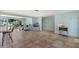 Spacious living room with tile floors, natural lighting, and views of the backyard pool area at 506 69Th St, Holmes Beach, FL 34217