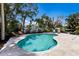 Gorgeous kidney-shaped pool with lush tropical landscaping and sunny patio at 506 69Th St, Holmes Beach, FL 34217